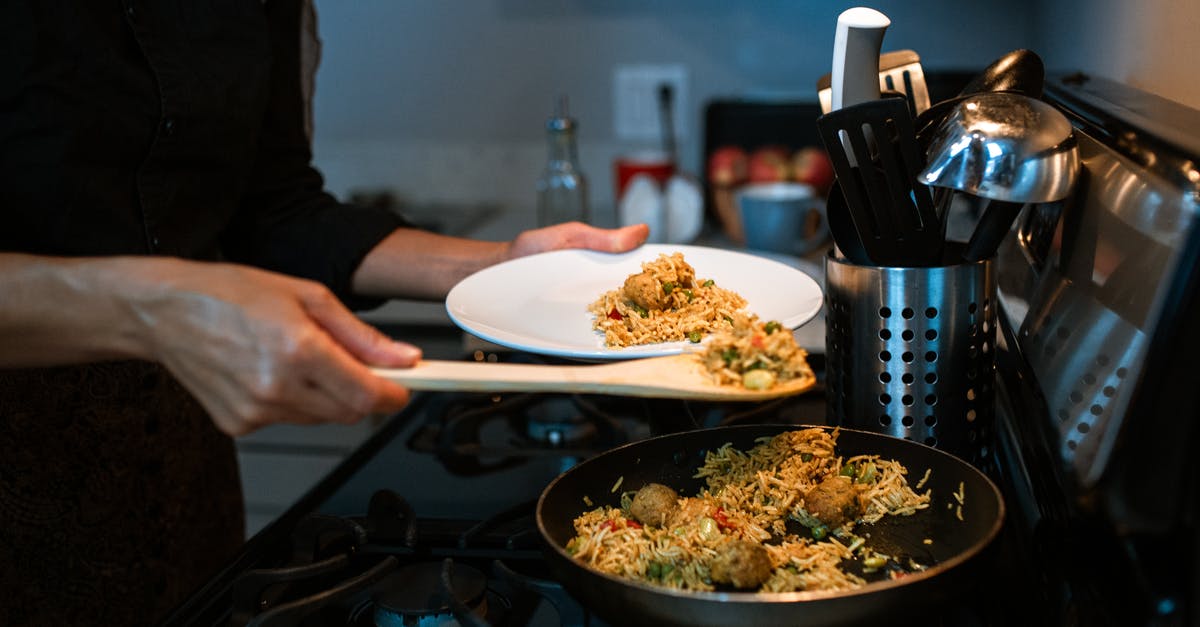 10-kilo biryani rice in check-in baggage - A Person Putting Fried Rice on a Plate