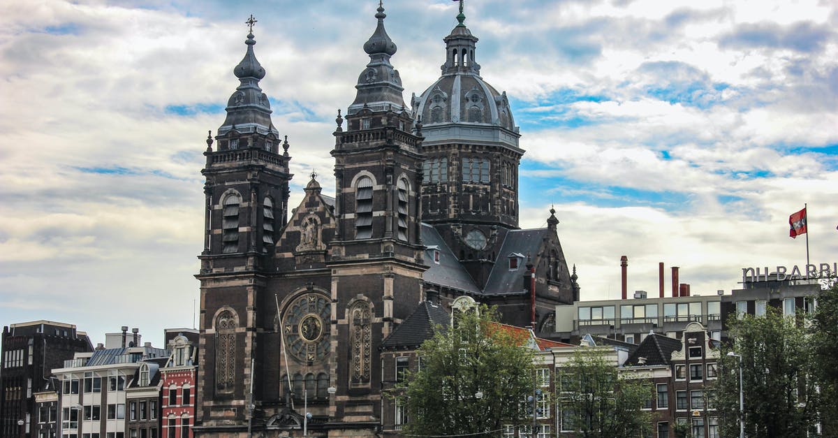 1.5 hr layover in Amsterdam - Brown and Black Concrete Building Under White Clouds