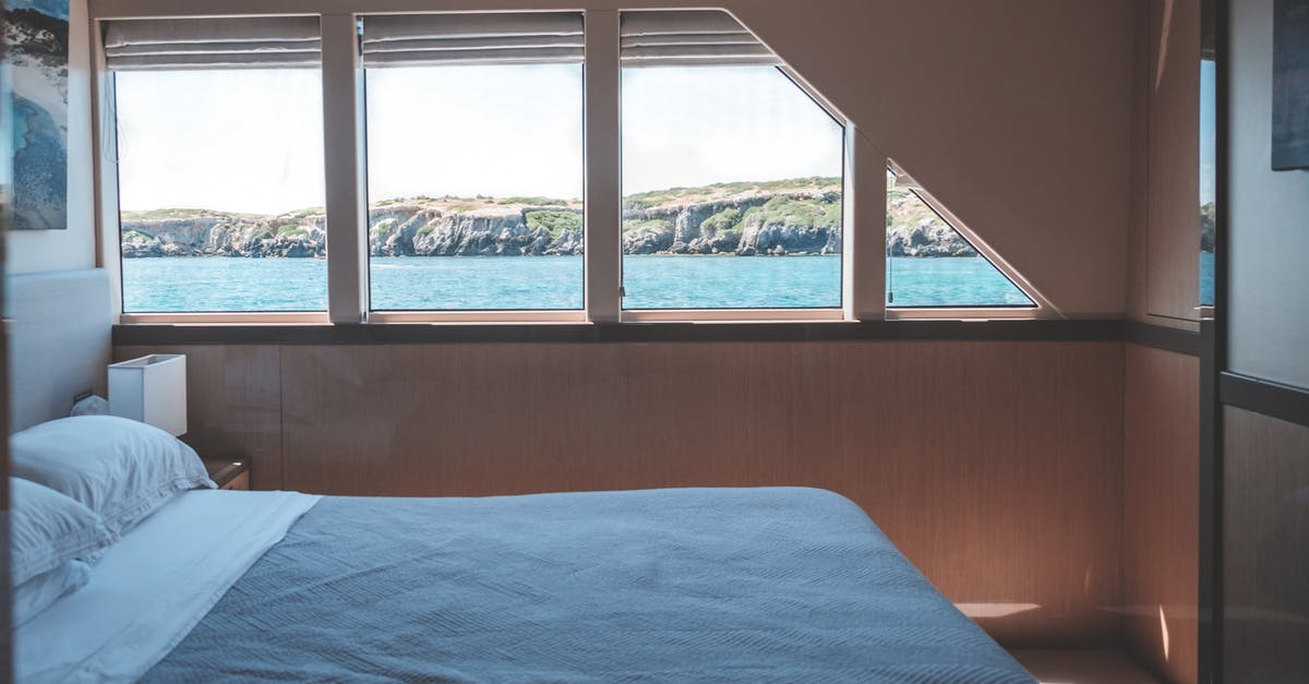 16 Hour Marine Atlantic Ferry Trip with no Cabin - Interior of cabin in modern yacht with comfortable bed and windows overlooking picturesque sea and rocky cliff on sunny day