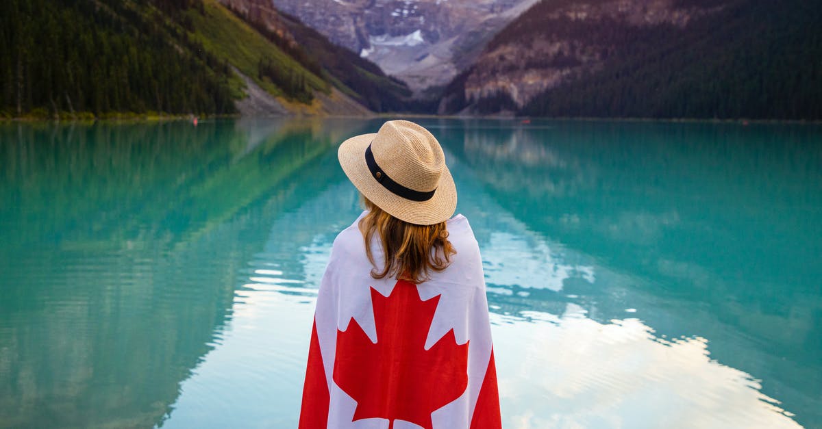 17 to canada and back [duplicate] - Photo of Woman Standing Near the Lake