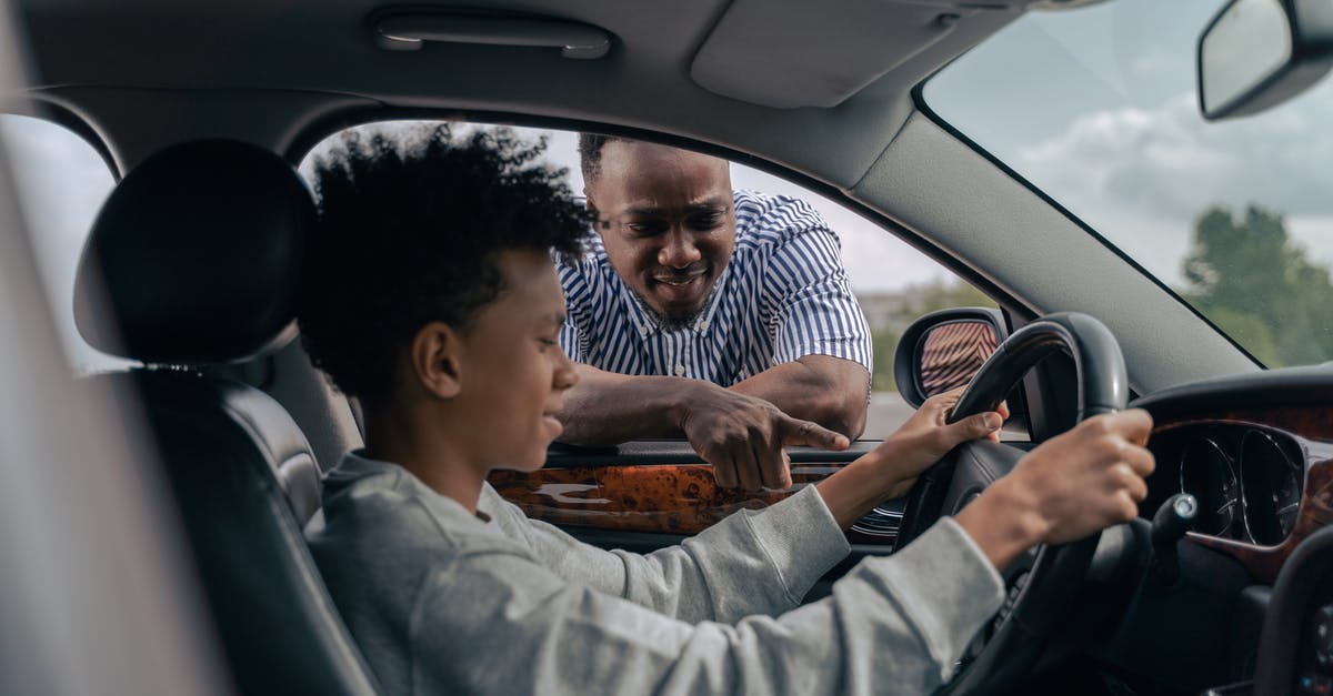 1 day Schengen overstay FRA - Man in Blue and White Striped Dress Shirt Sitting on Car Seat