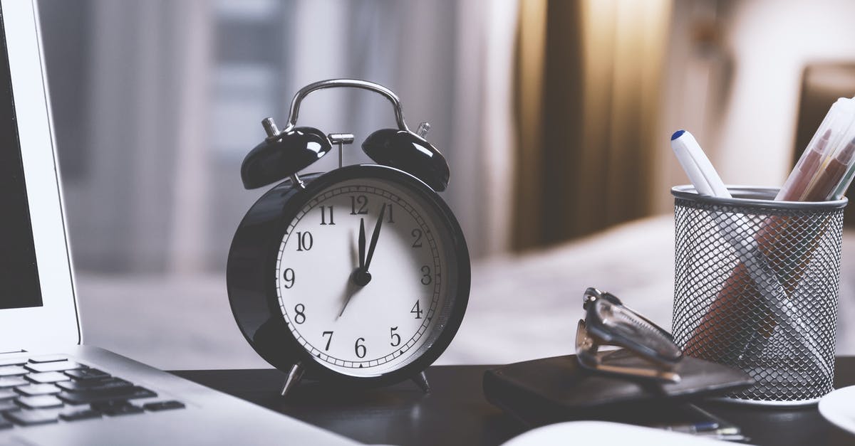 2 hours layover in Heathrow - Black Twin Bell Alarm Desk Clock on Table