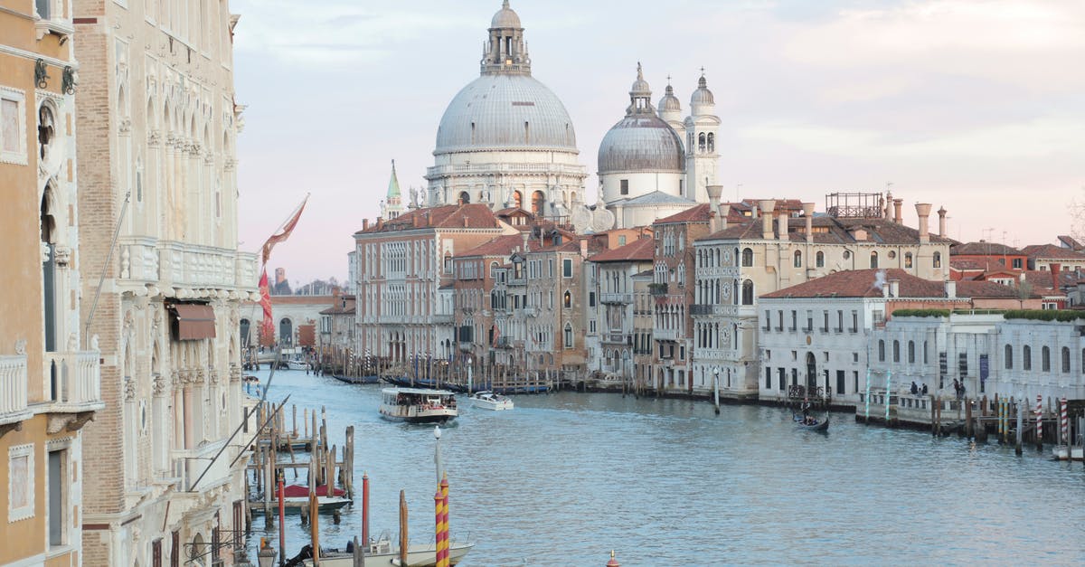 2-layover trip in europe with F1 visa [duplicate] - View of grand canal and old cathedral of Santa Maria della Salute in Venice in Italy on early calm morning