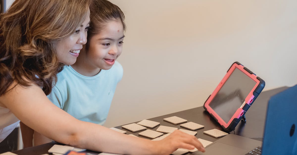 'One laptop per child'- like organisations? - A Woman and Her Daughter Looking at a Laptop Together