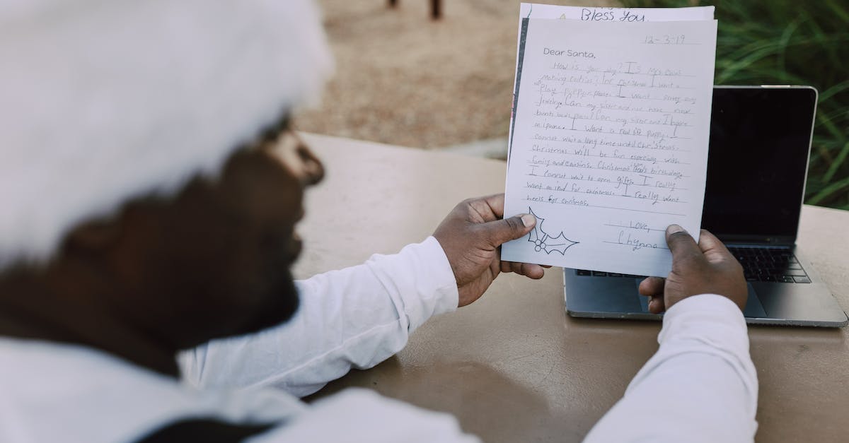 'One laptop per child'- like organisations? - Man in White Long Sleeve Shirt Holding White Printer Paper