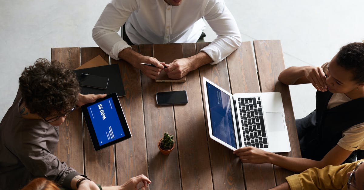 3 laptops and 2 tablets from Chicago to Chennai [duplicate] - Top View Photo of People Having a Meeting