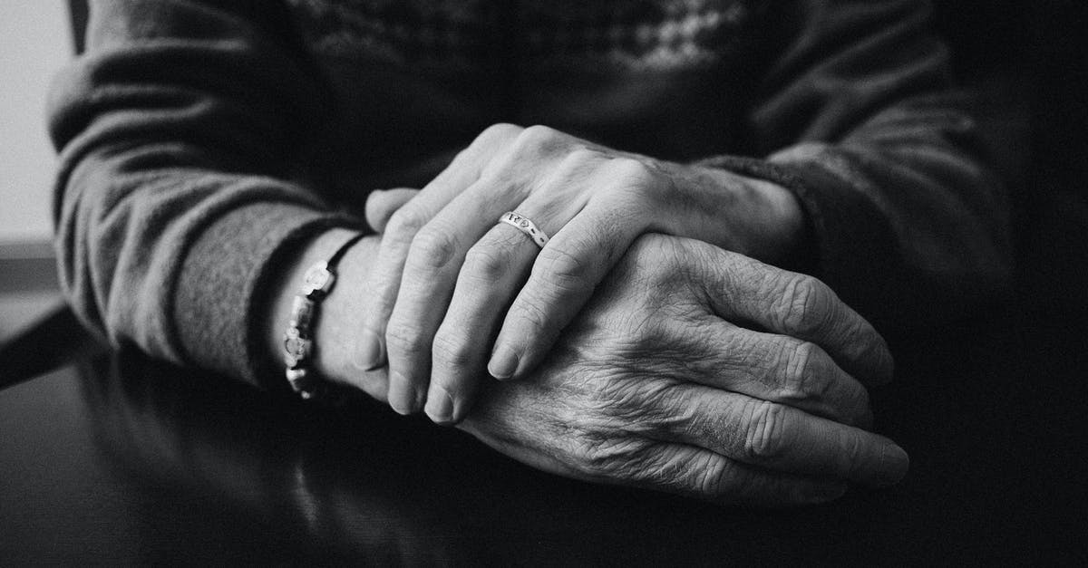 3 month old's hands swabbed at security? - Grayscale Photo of a Person Wearing Ring