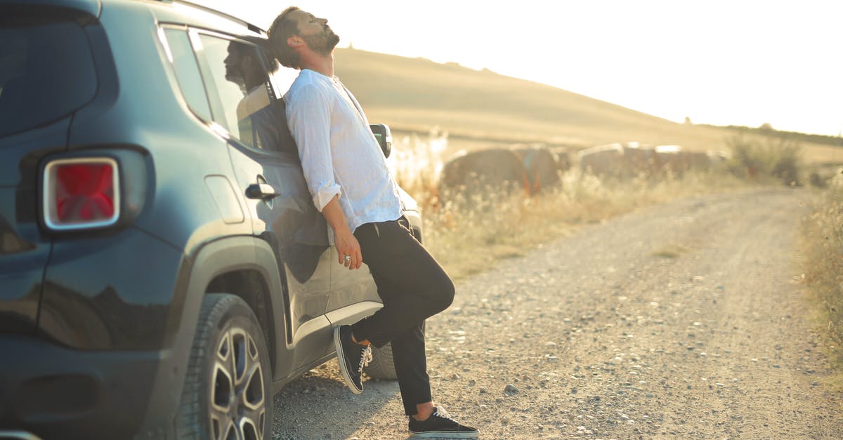 4x4 Rental in Northern Idaho - Man in White Dress Shirt and Black Pants Leaning on White Car