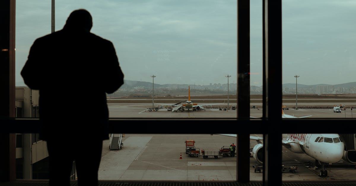 50 Minute Layover In Casablanca Airport - Silhouette of Person Standing Near Glass Windows