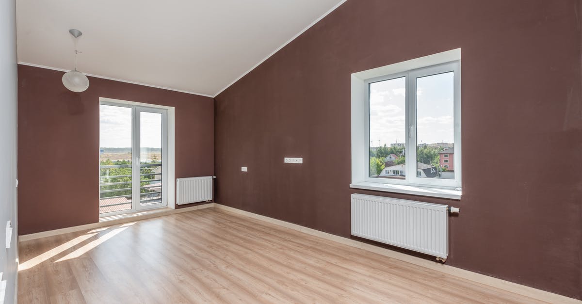 55-floors residential blocks next to the airport - Brown Wooden Parquet Floor Near White Framed Glass Window