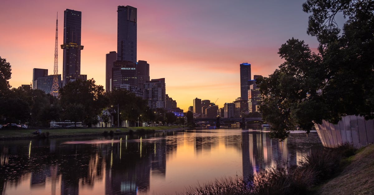6 hours in Melbourne Airport, with bags! - Reflection of Buildings on Yarra River during Sunset