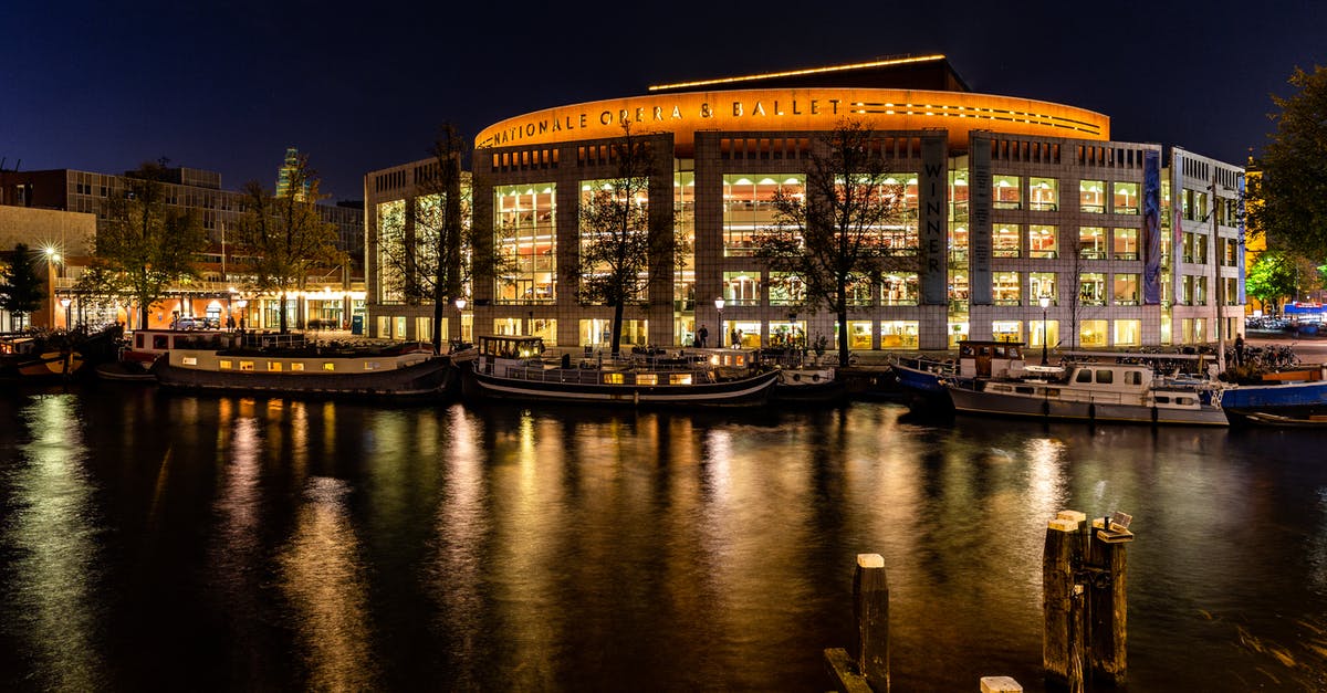 6hour layover in Amsterdam - Brown Wooden Dock on River during Night Time