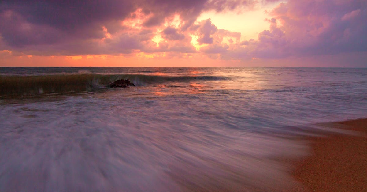 90 day holiday visa for South Korea - Spectacular seascape of wavy ocean near sandy beach under bright sunset in summer time