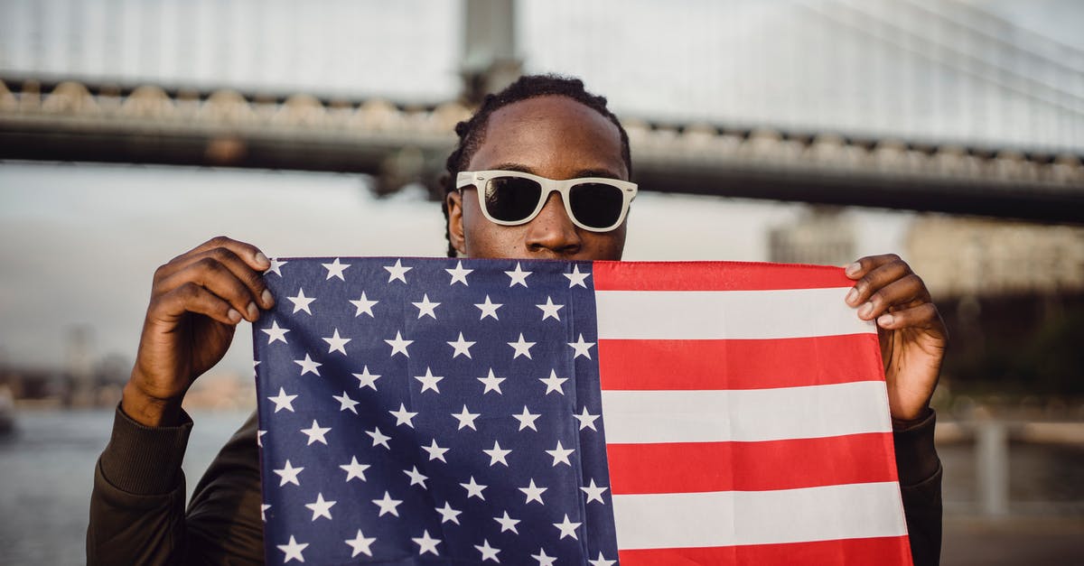 90 days stay with tourist visa in USA - Young African American male with American Flag bandana against bridge