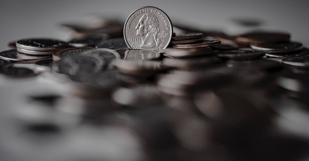 A good substitute for bank statement - Silver Round Coins on Brown Wooden Surface