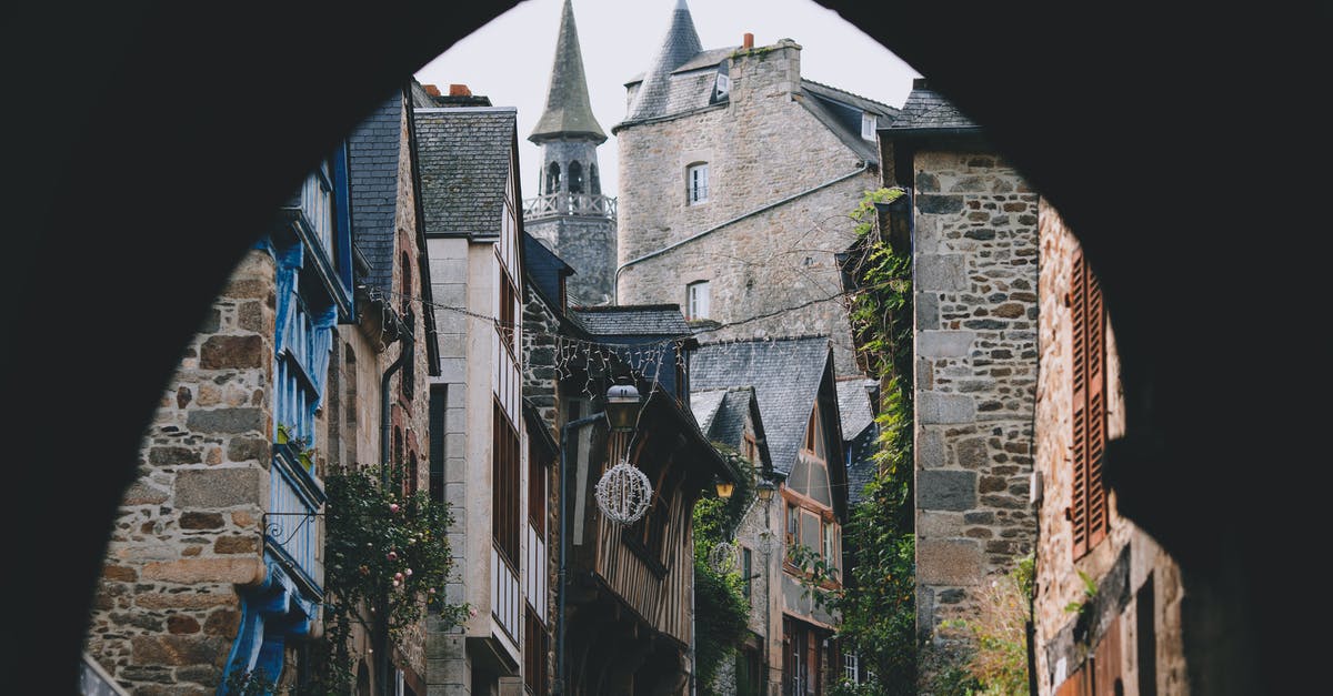 A quick trip to France whilst on holiday in the UK - Narrow street of old town with arched passage and typical stone houses