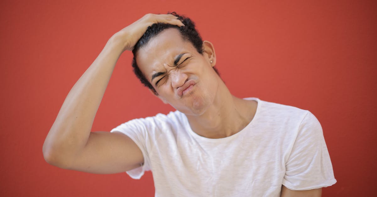 a weird "no turn on red" traffic ticket [closed] - Young displeased man with piercing making face