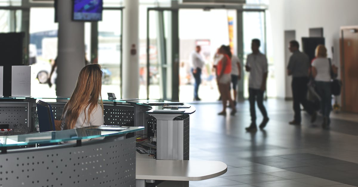 About luggage details in Doha airport - White Sitting Behind Counter Under Television