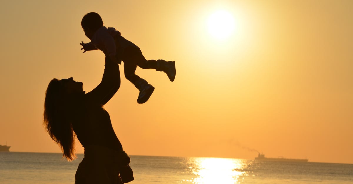 About Schengen Visa 180 days rule - Silhouette Photo of a Mother Carrying Her Baby at Beach during Golden Hour