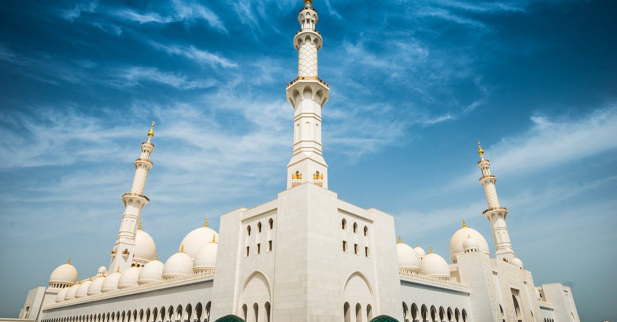 Abu Dhabi to Muscat? - White Painted Buildings Under Blue Sky