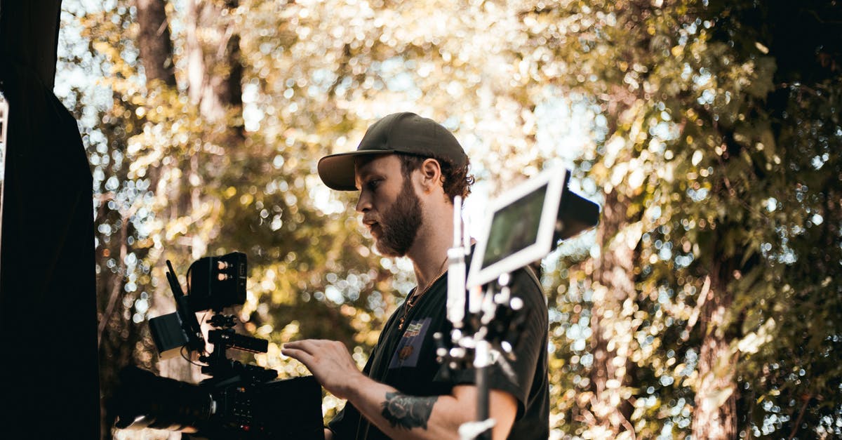 Acceptable terms for describing black people in California - Man in Black and White Shirt Holding Video Camera