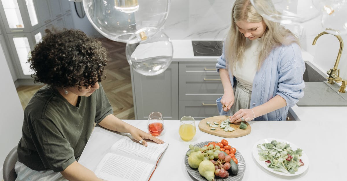 Acceptable ways to bring Fruits and Vegetables into the US - Woman in White Long Sleeve Shirt Sitting Beside Woman in White Long Sleeve Shirt