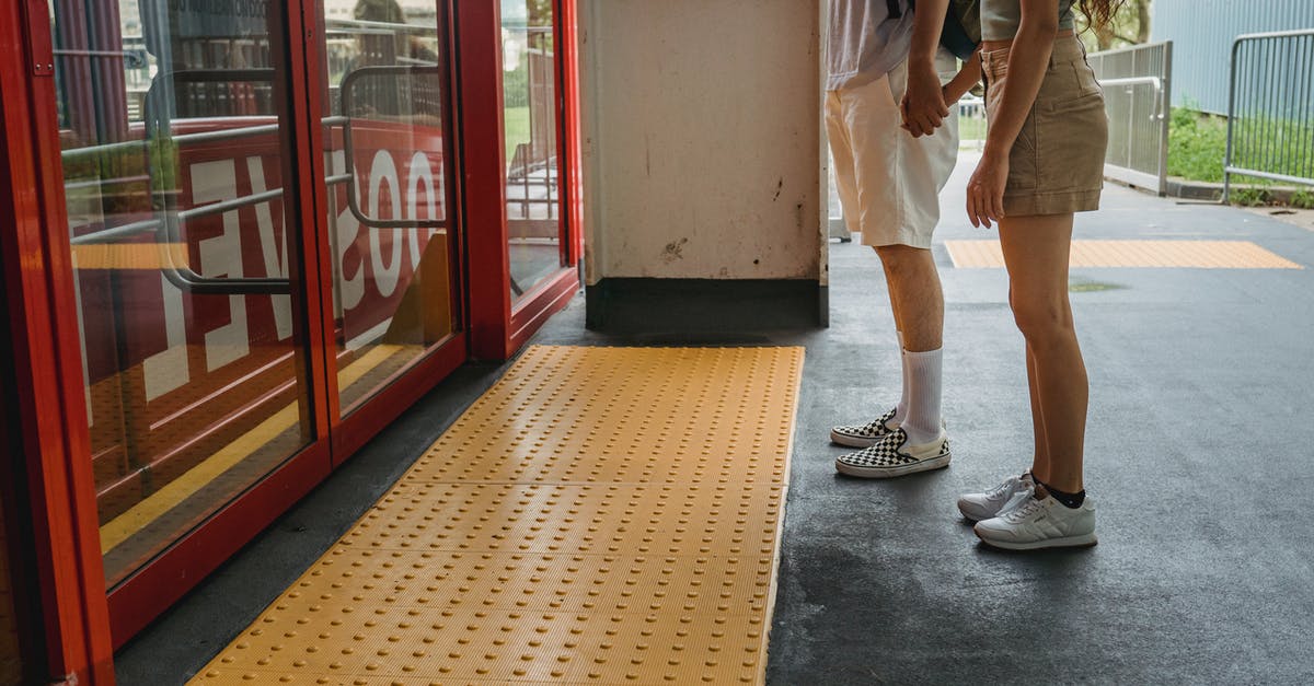 Access to Midosuji line platforms with luggage - Young couple holding hands while waiting for funicular