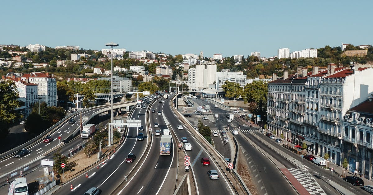 Accommodation while driving from Calais towards Paris - Highway with traffic between residential buildings in city district