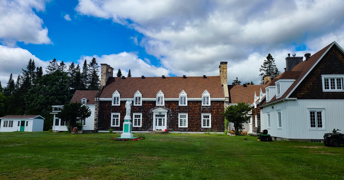 Accompanying friend for a Canada visa? - White and Brown Concrete House Under Blue Sky