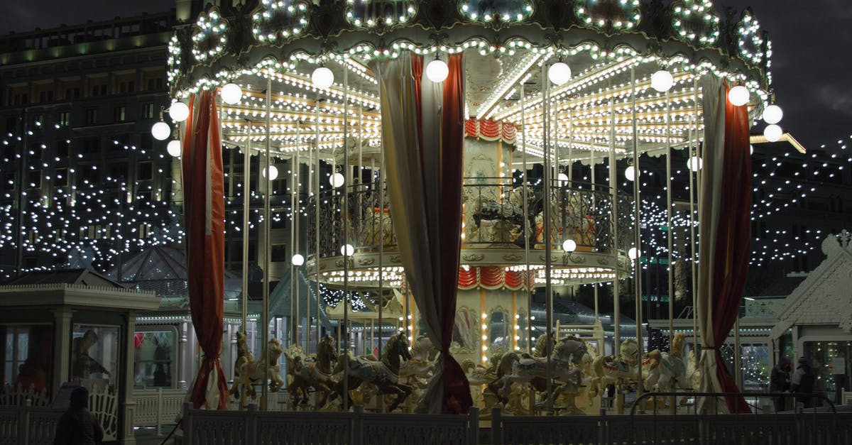 Activities in Warsaw during a public holiday [closed] - Illuminated merry go round in amusement park at night