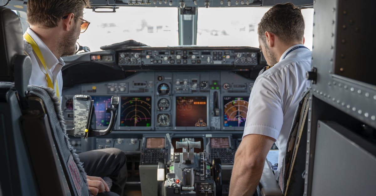 Additional cabin handbag on flights - Two Pilots Sitting Inside Plane