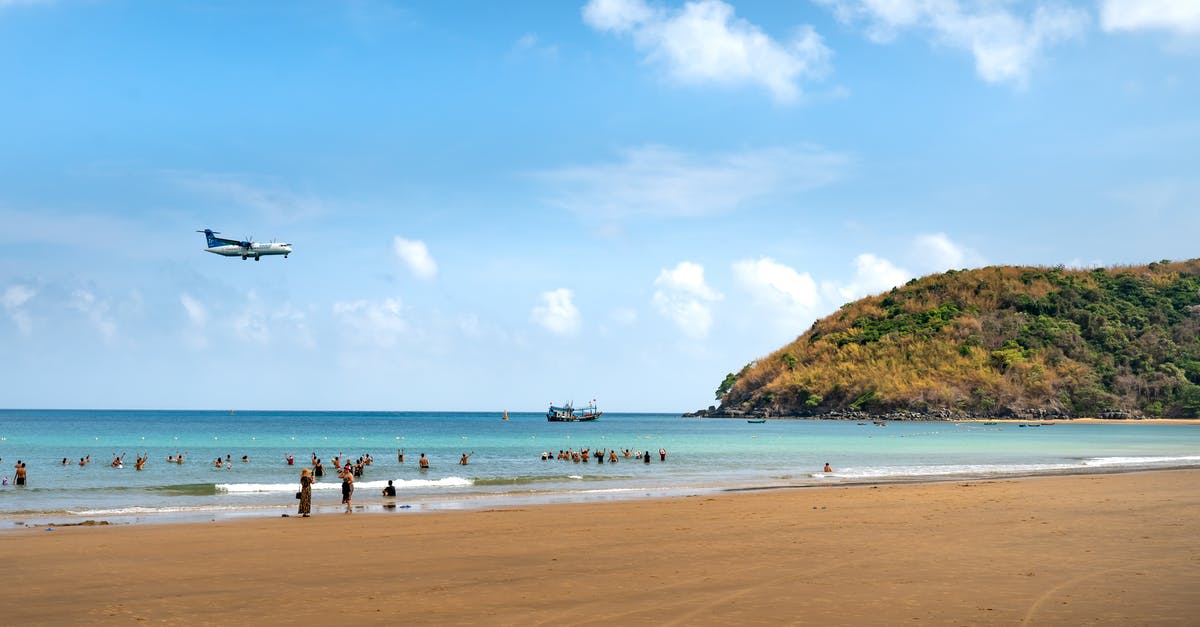 Additional flight appeared on my booking with Emirates - An Airplane Flying Over People on the Beach