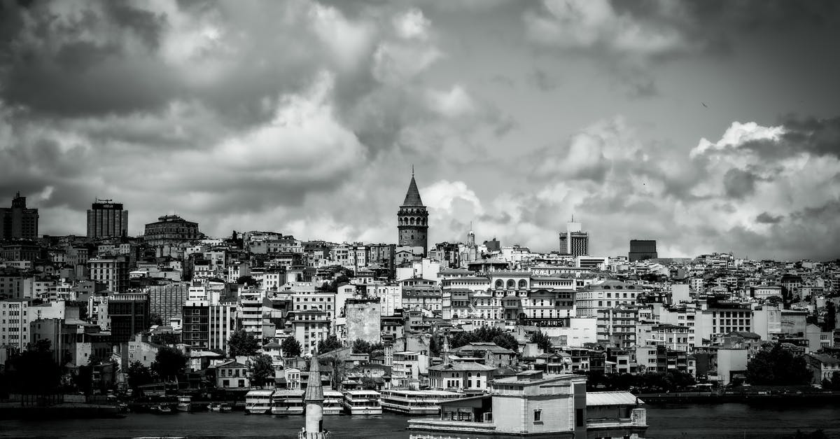 Address in Turkey eVisa - Grayscale Photo of City Buildings Under Cloudy Sky