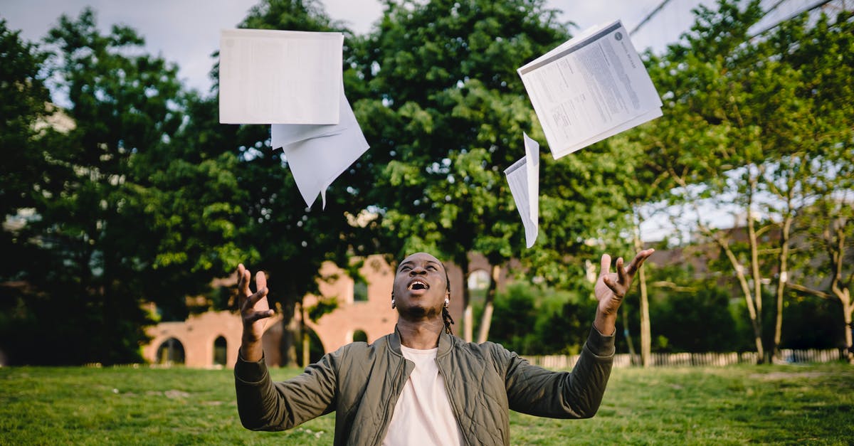 Administrative Review result mail - Visa Tier 4 Student [closed] - Happy young black male freelancer throwing papers while celebrating successful project during remote work in green park