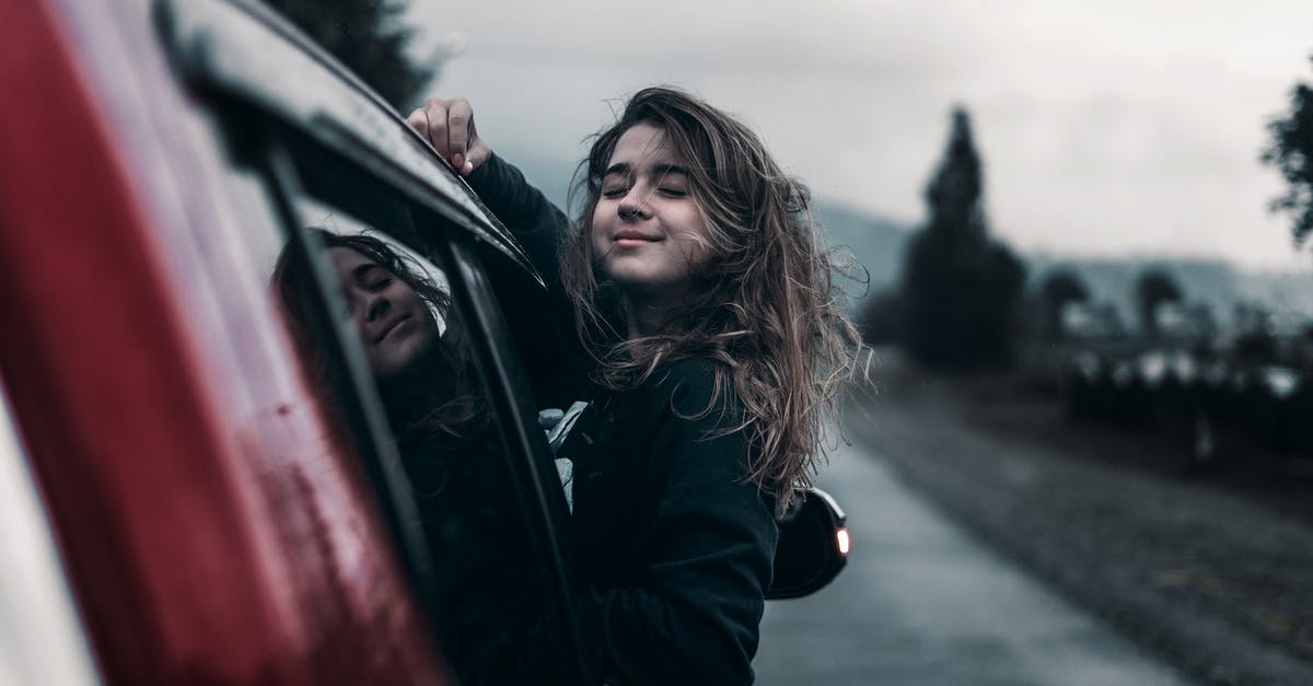 Advice on a road trip to Dolomites [closed] - Young female leaning out of car window