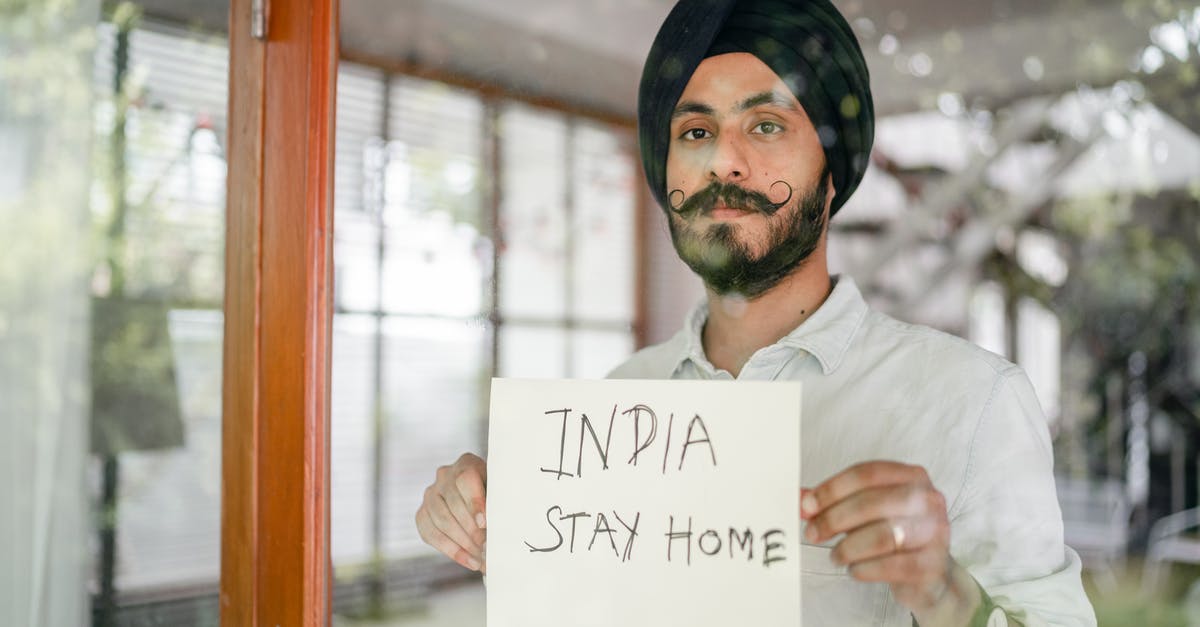 Advice on damaged Indian passport [duplicate] - Bearded modern Sikh with paper in hands behind glass wall