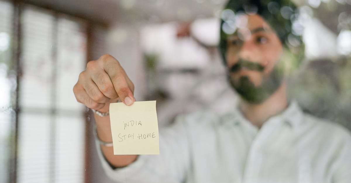 Advice on damaged Indian passport [duplicate] - Indian man showing paper sheet while standing behind glass wall