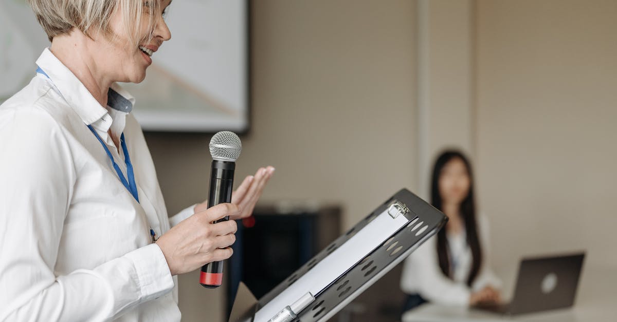 advice when talking to canadian passport control agent when speaking at a conference? [closed] - A Woman Holding a Microphone