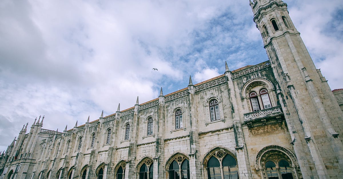 Air Canada luggage allowance when flying from Europe to USA - Facade of Jeronimos Monastery near lawn under cloudy sky