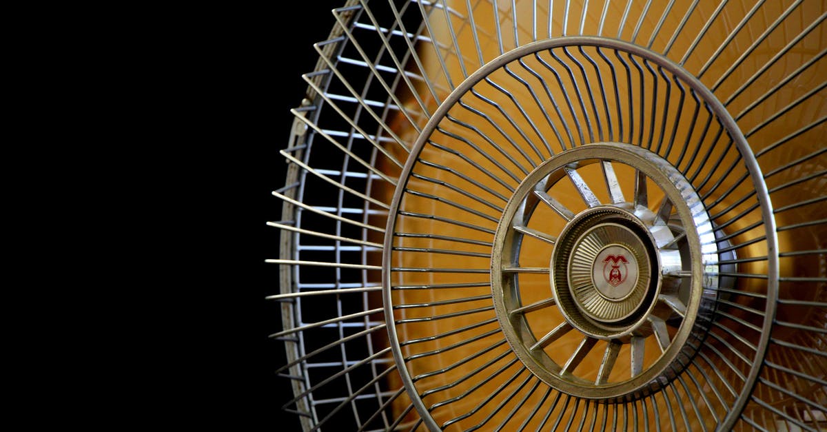 Air fare refund & reschduled [closed] - Close-up Photography of Gray Stainless Steel Fan Turned on Surrounded by Dark  Background