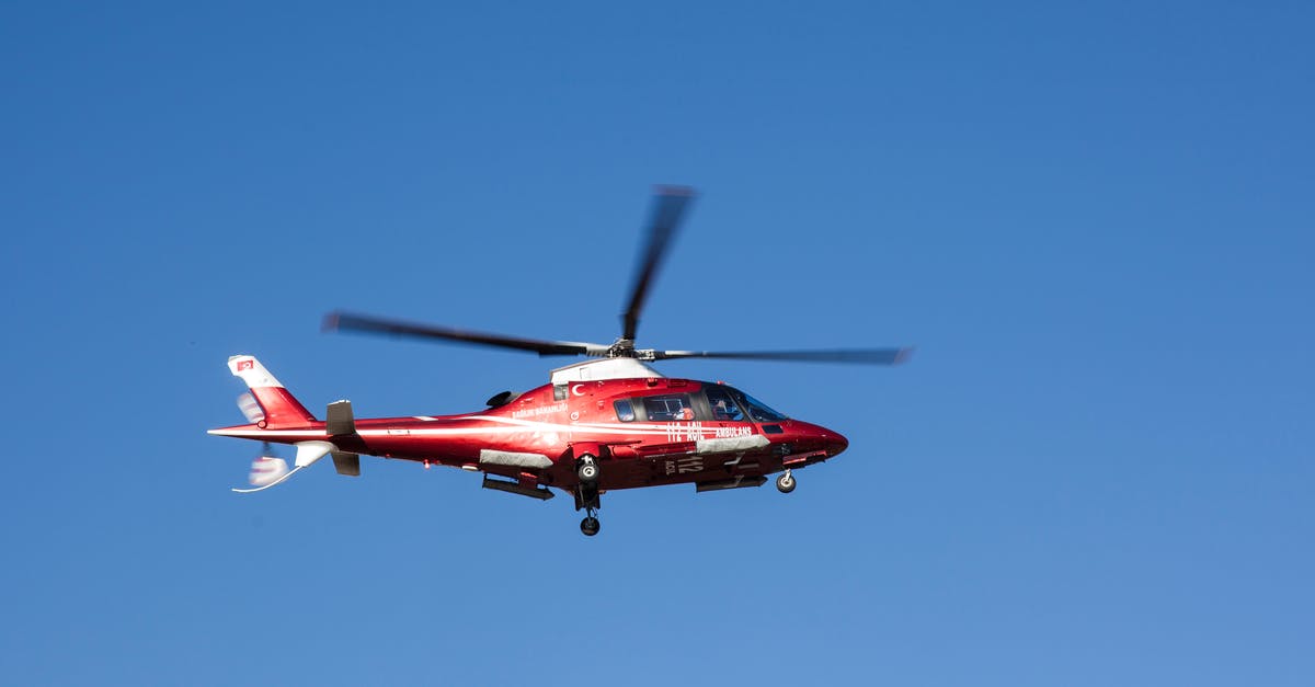 Air travel in Canada with a medical implant - Flying Red and White Helicopter