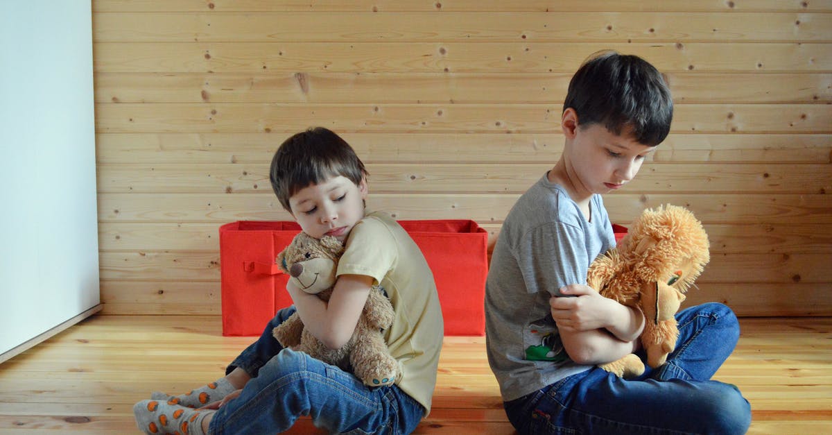 Airbnb housing gone electrifyingly bad - Sad little siblings hugging toys on floor