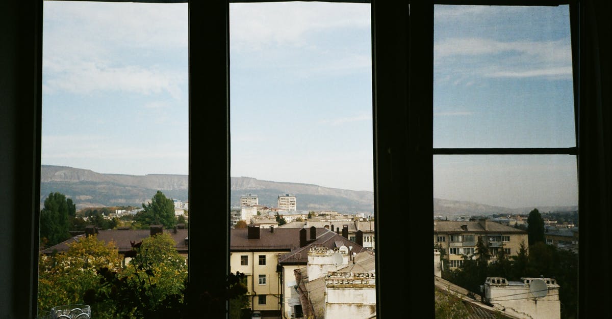 Air-conditioned cafe in Kampot, Cambodia? - Cafe window facing old town and mountain in daylight