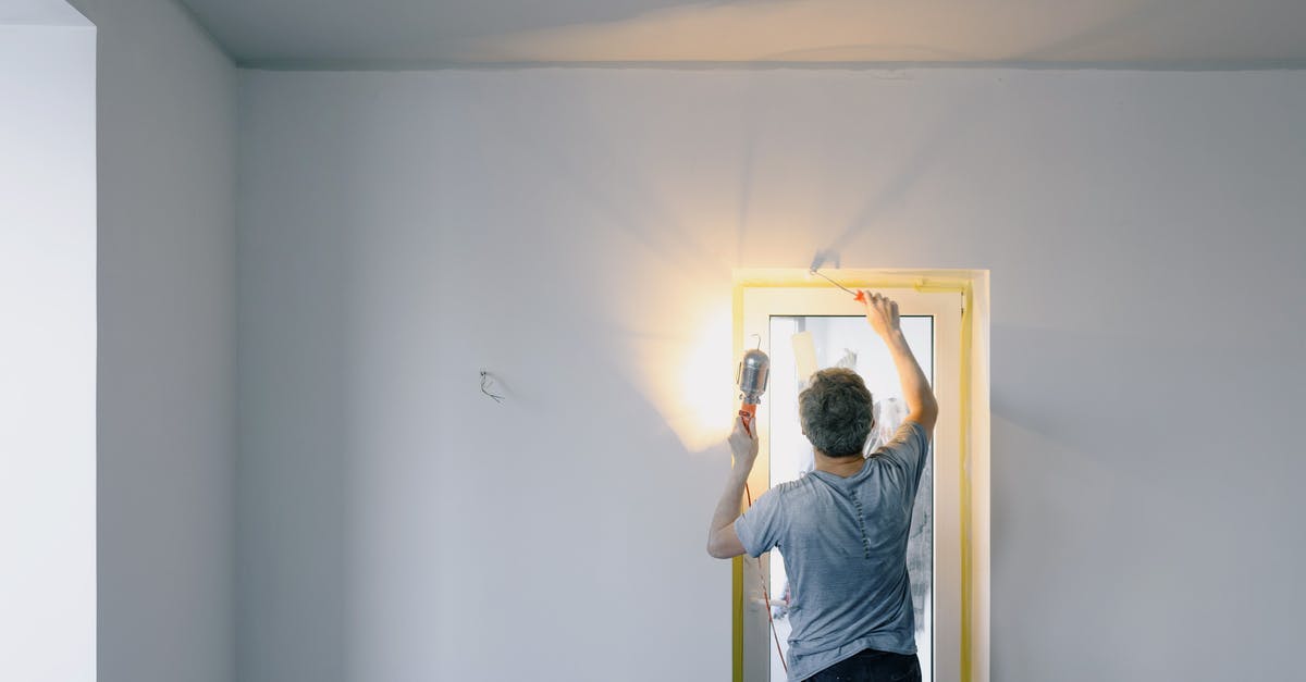 Airline Change of Equipment Code - Faceless man repairing door in room