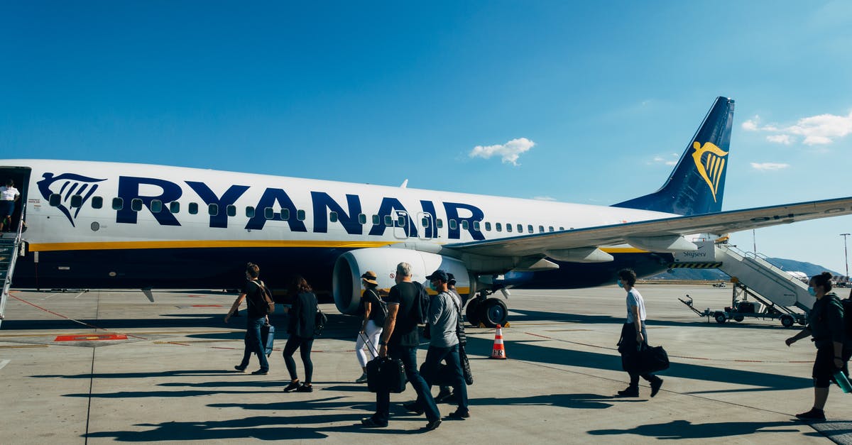 Airline fares - meaning of "plus fare difference" for refund - People Walking Near White and Blue Airplane