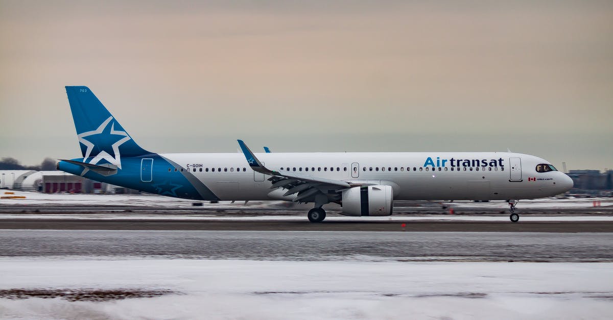 Airline flies, even though we aren't allowed to enter Canada - Passenger aircraft moving on airfield after landing in airport during sunset on winter day