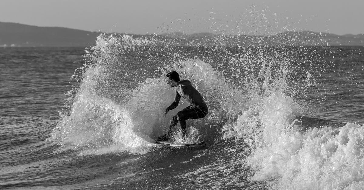 Airlines with the most Surfboard friendly baggage policy & fees pricing? - Grayscale Photo of Man Surfing