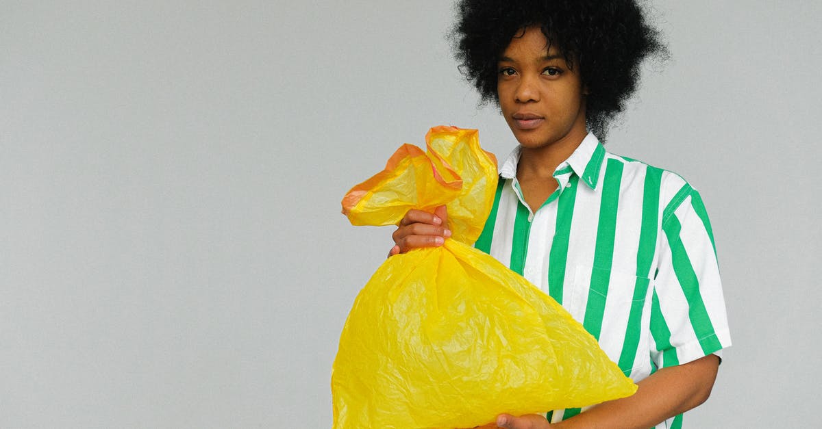 Airplane carry-on allowance and plastic bags - Woman in White Green Stripes Polo Shirt Holding Yellow Plastic Bag