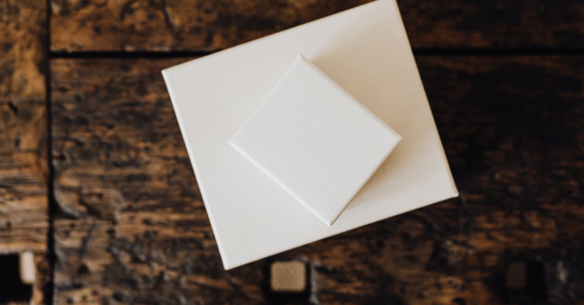 Airplane Seats and overhead storage - Stack of white carton boxes on wooden table