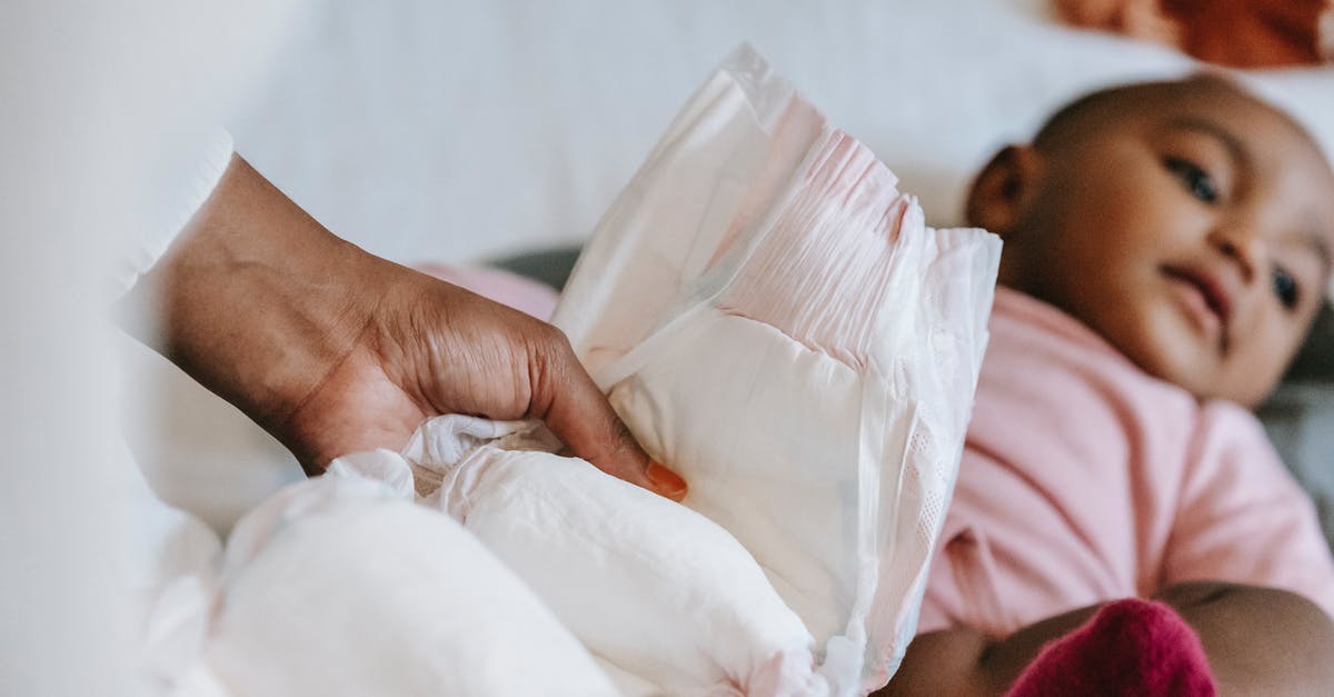 Airport Change from La Guardia TO JFK [duplicate] - Black mother changing diaper for baby